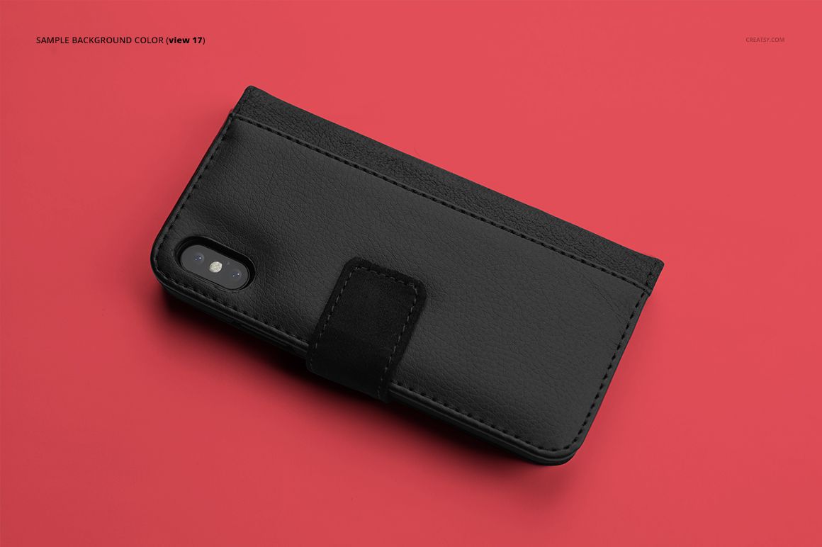 PSD mockup of a black iPhone X foldable case lying closed on a vibrant red surface.