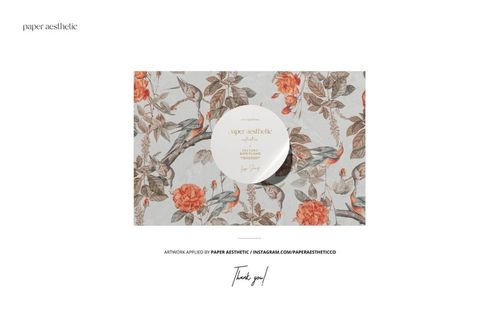 Creased fabrics mockup displaying a detailed botanical and bird design with orange flowers and muted leaves.