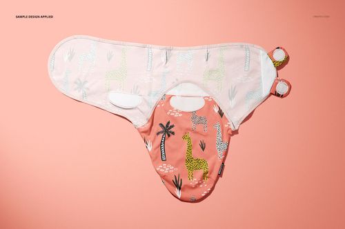 Adjustable baby swaddle wrap mockup displayed on a peach background, featuring giraffe and tree patterns in pastel colors.