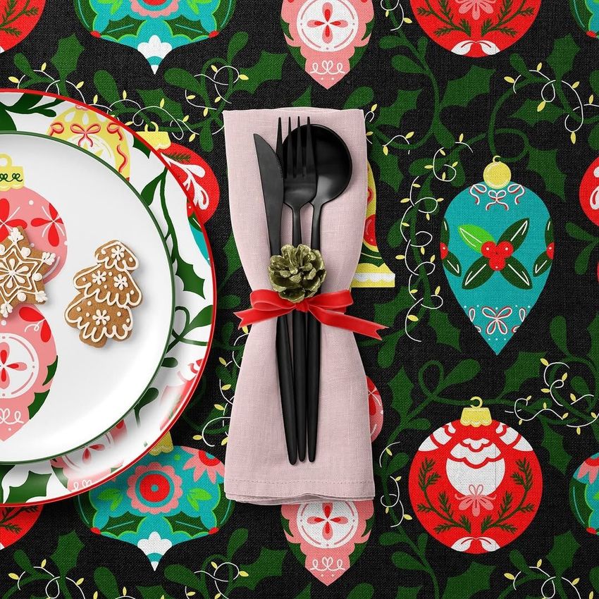Plate, napkin, and tablecloth mockup featuring a festive Christmas pattern with colorful ornaments and holiday cookies.