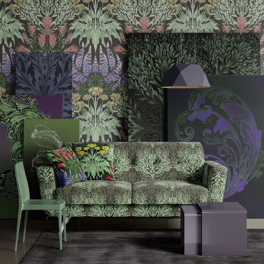 Modern sofa mockup with sage green botanical pattern, surrounded by matching patterned wall art and decor in a living room scene.