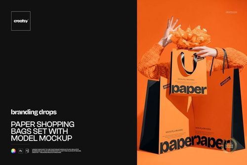 PSD mockup showing a model holding bright orange paper shopping bags with bold black text, against an orange backdrop.