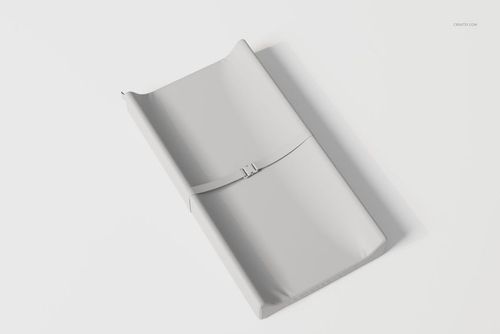 Contoured changing pad in light gray color shown from a high angle on a plain white background surface.