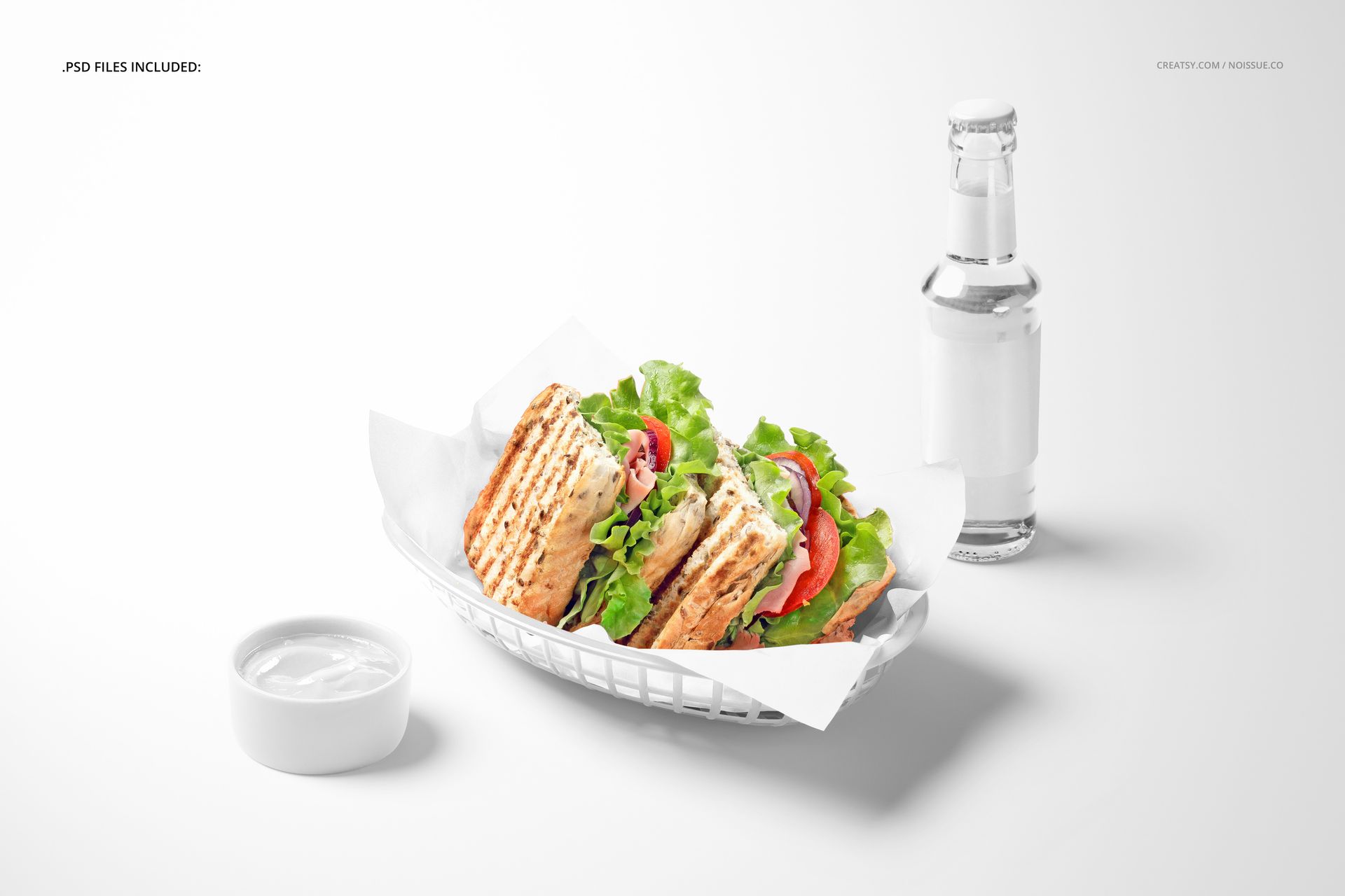 Sandwich wrapped in food safe paper mockup displayed in a white basket, with lettuce and tomato, front view.