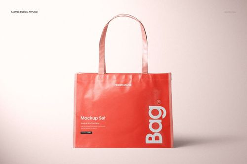 Laminated non-woven tote bag mockup shown upright against a neutral background, coral color with bold white typography.