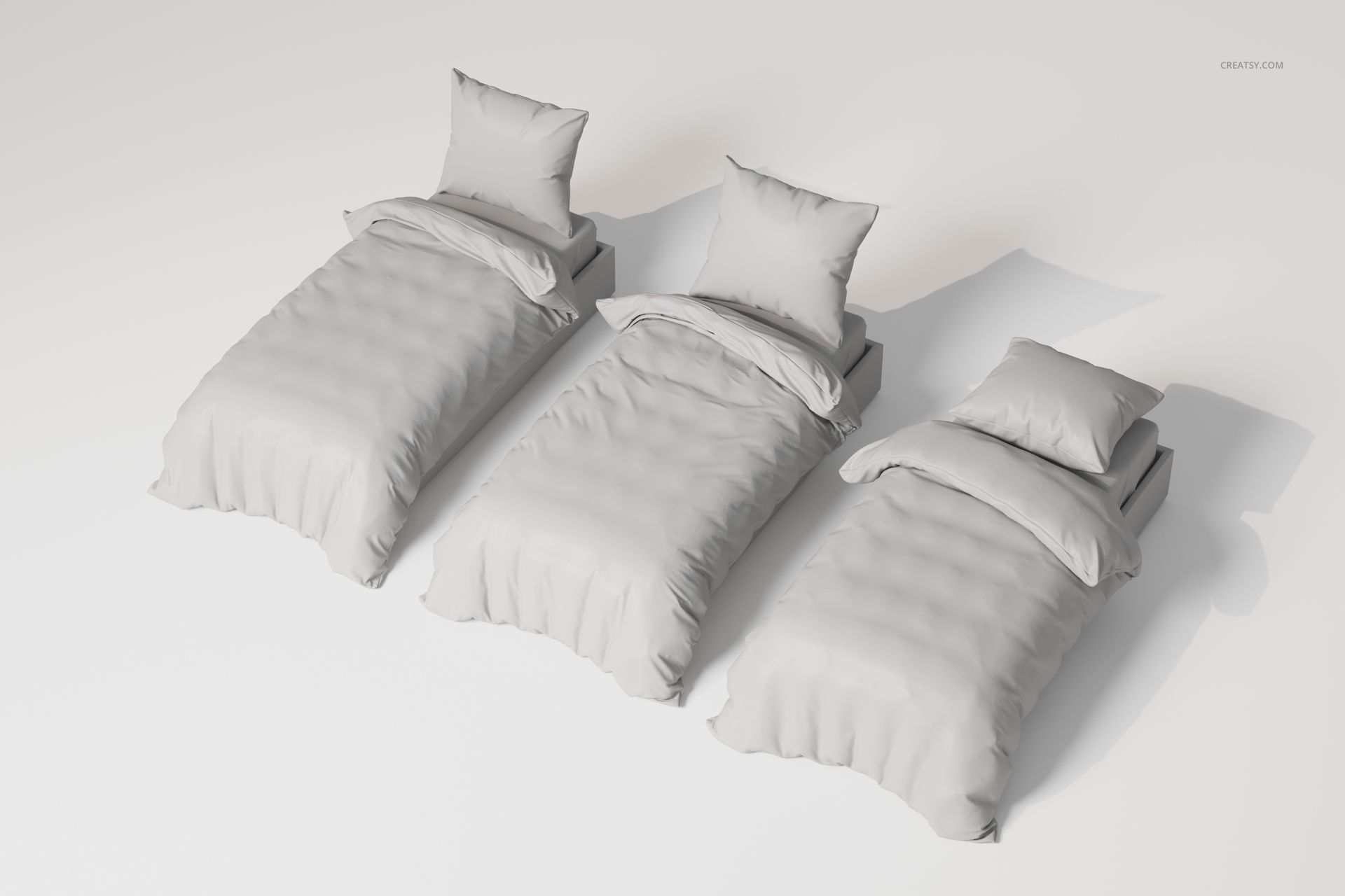 Three single bed bedding sets in light gray, arranged side by side on a plain white surface, viewed from above.