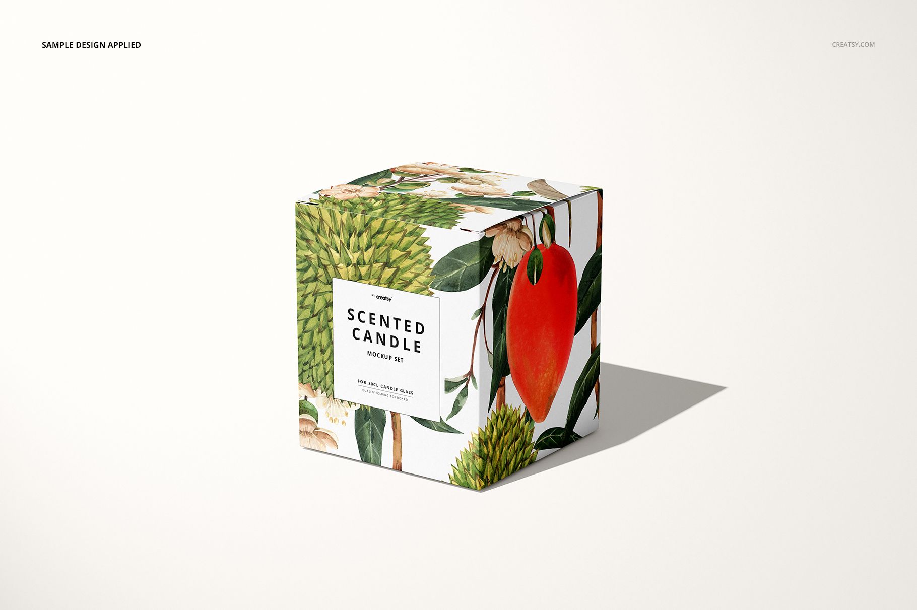 Square candle packaging mockup featuring colorful botanical and fruit artwork, shown from a front angle.
