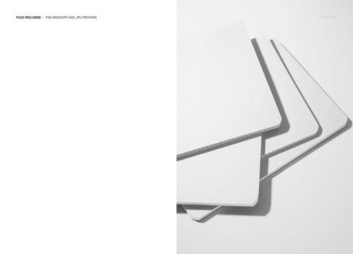 Top view of four plain white notebooks arranged in a fanned layout on a light surface, stationery mockup scene.