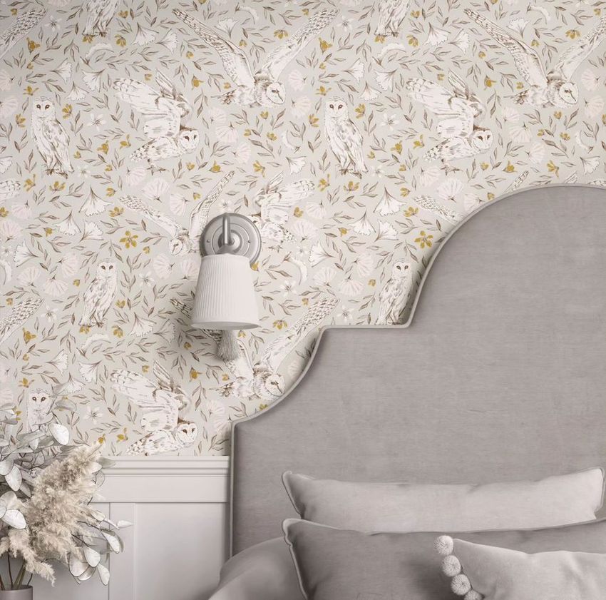 Bedroom pillows, a curved upholstered headboard, and wallpaper with a white owl pattern in a neutral-toned room mockup.