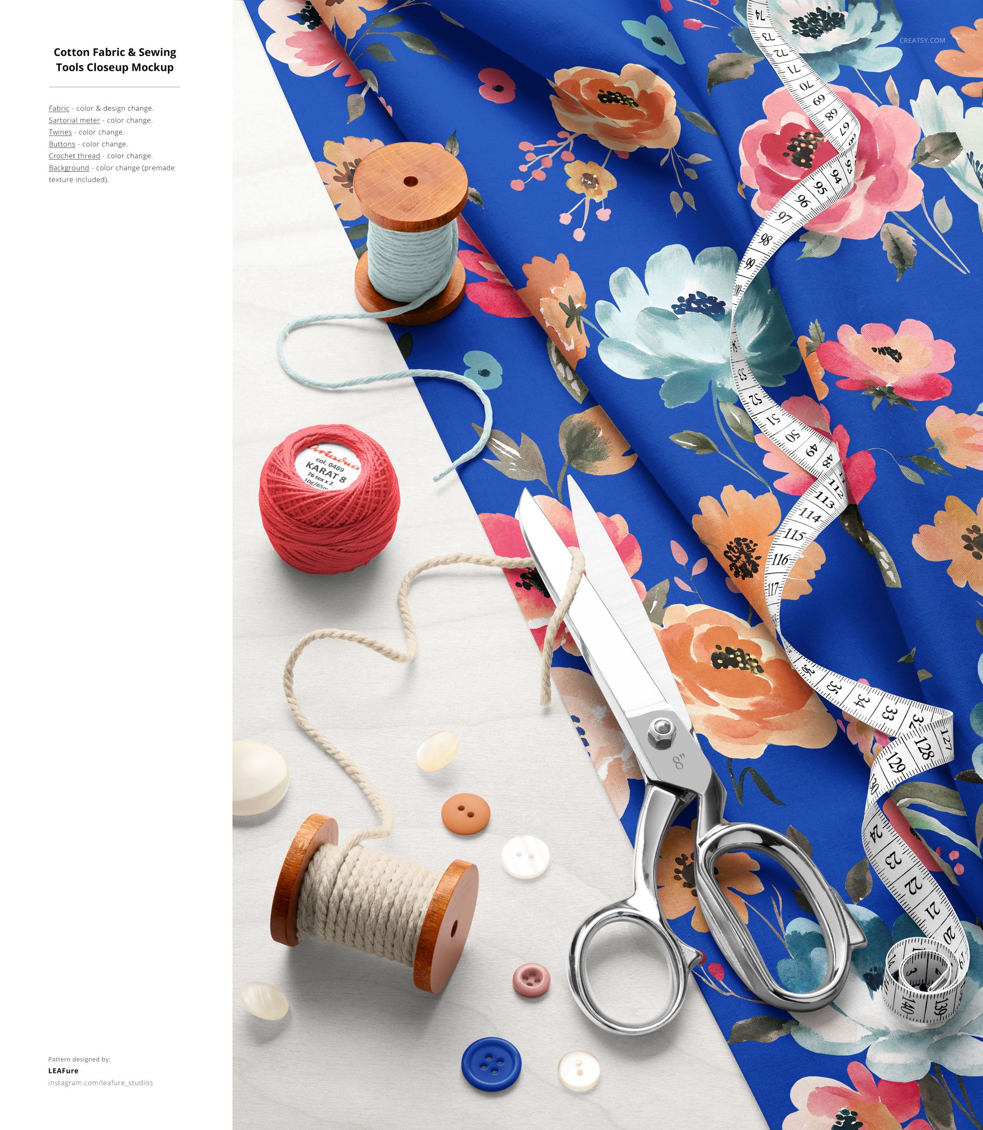 Overhead shot of floral cotton fabric mockup with sewing tools, including scissors, thread, buttons, and measuring tape.