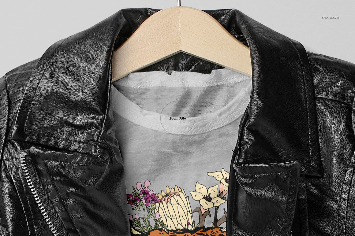 Front view of a girls chic set mockup featuring a white t-shirt with floral graphic under a black leather jacket on a hanger.