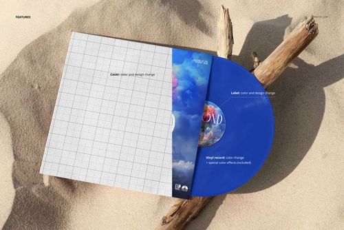 PSD mockup of a blue vinyl record and album cover resting on sandy surface with a piece of driftwood beside them.