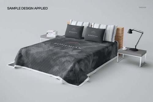 Perspective view of a quilted bed coverlet mockup in dark tones, styled on a wooden bed with striped pillows.