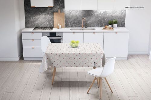 Rectangular table with a light patterned tablecloth mockup in a contemporary kitchen, viewed from a front angle.