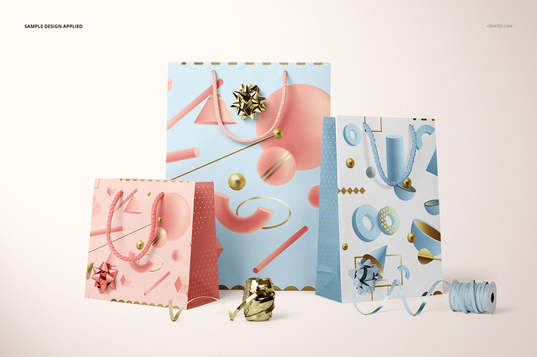 PSD mockup featuring three gifting edition paper bags, each with colorful abstract prints, metallic bows, and ribbon accessories.
