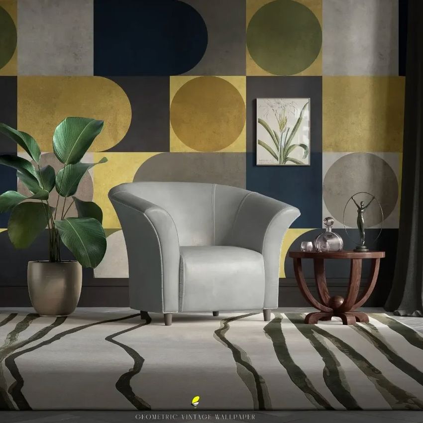 Tub armchair mockup in a living room scene with geometric patterned wallpaper, a potted plant, and a round wooden side table.