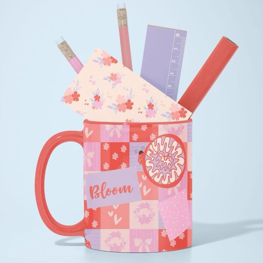 Mug mockup with a pink and red checkered floral pattern, filled with pencils, a floral notecard, and two rulers on a light background.