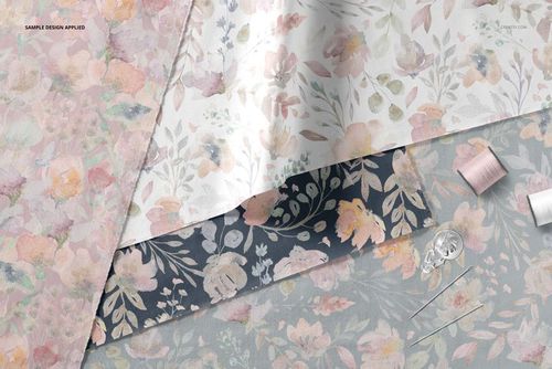 Layered fabric mockup showing three textile pieces with floral patterns in pastel and dark tones, top view.