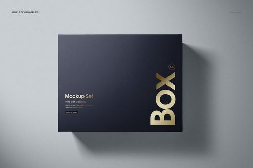 Top view of a navy blue magnetic gift box mockup featuring bold gold text, placed on a smooth gray background.