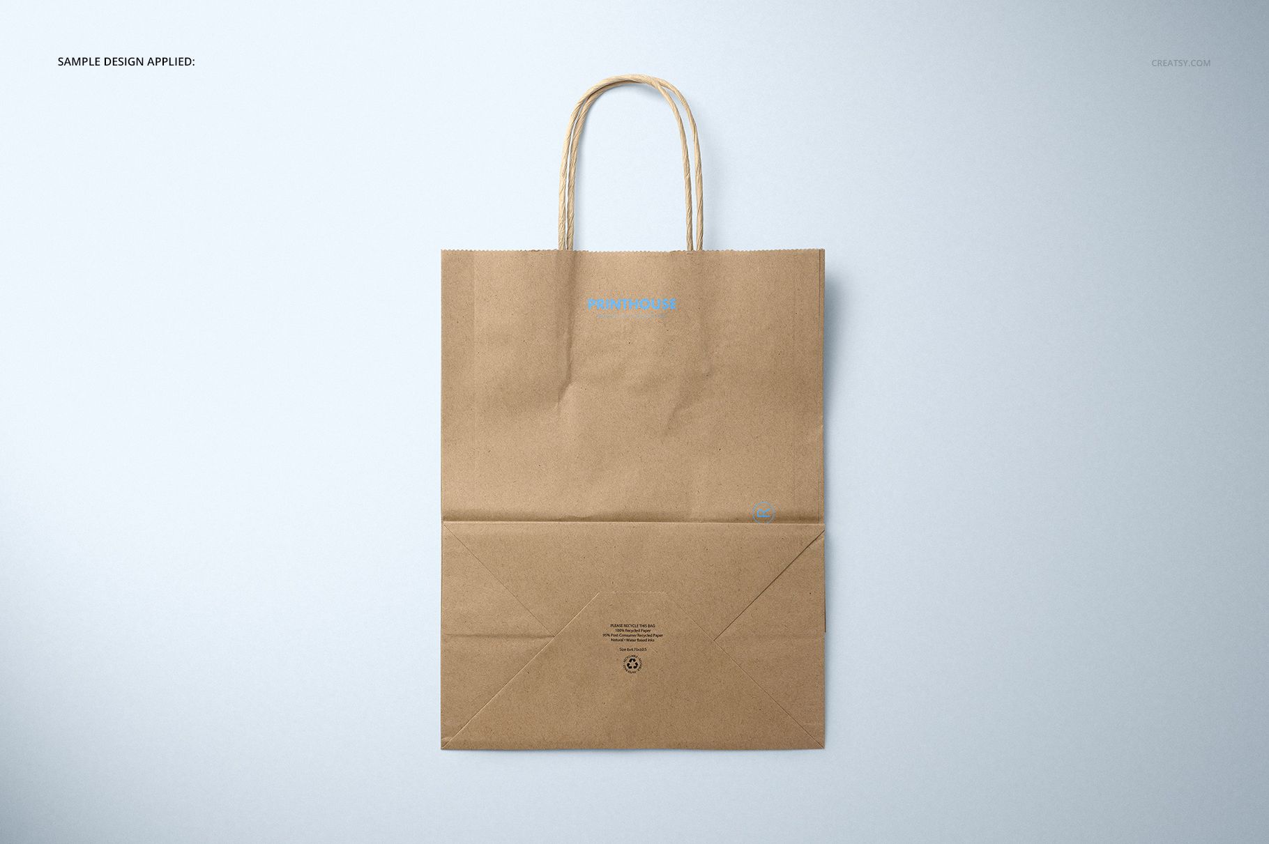 Brown kraft paper shopping bag mockup displayed flat, featuring visible bottom folds and simple handles.
