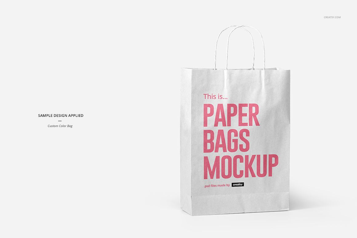 White paper bag mockup with pink lettering, shown upright with handles against a clean, light-colored backdrop.