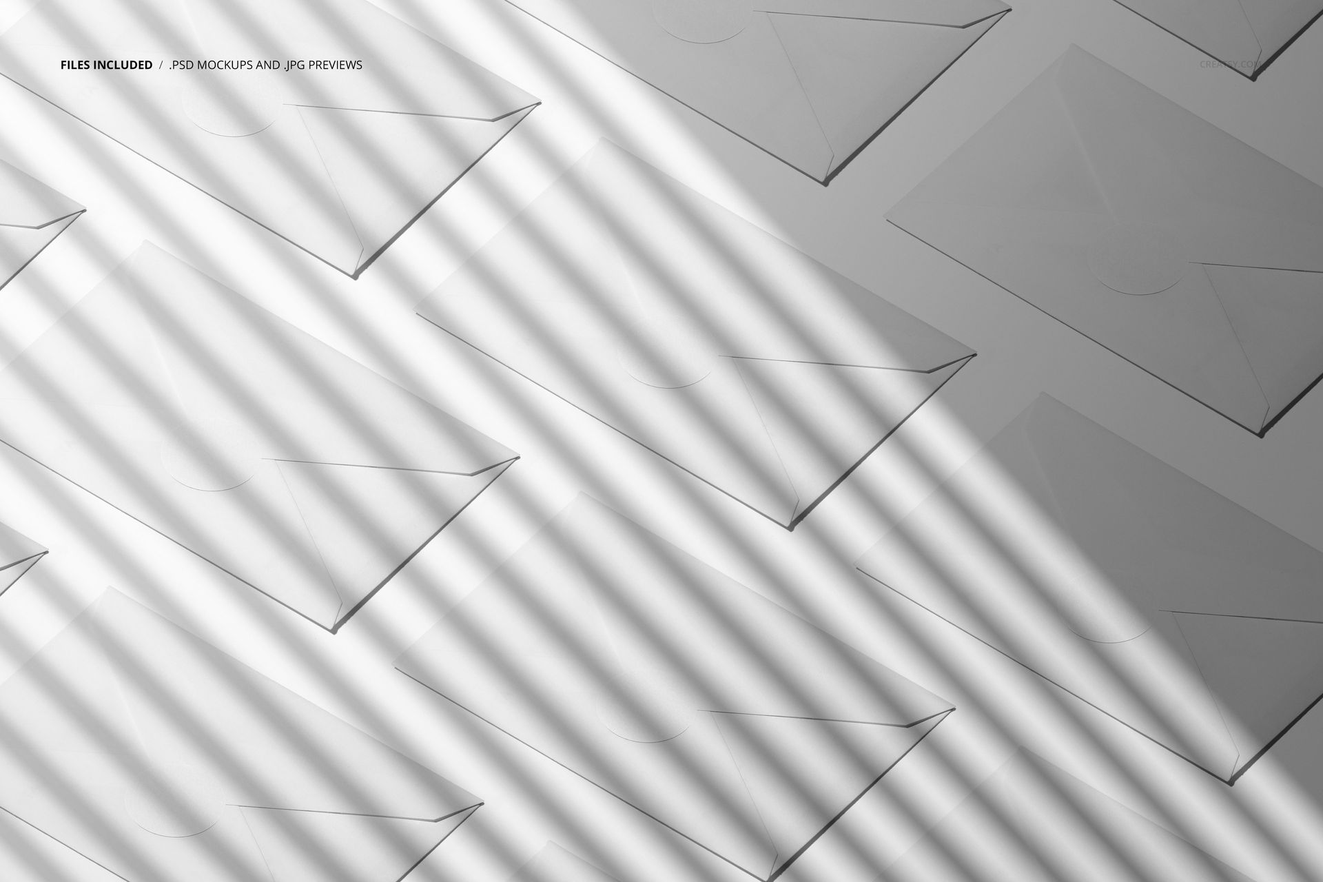 PSD mockup displaying several envelopes in a geometric layout, illuminated by angled sunlight casting linear shadows.