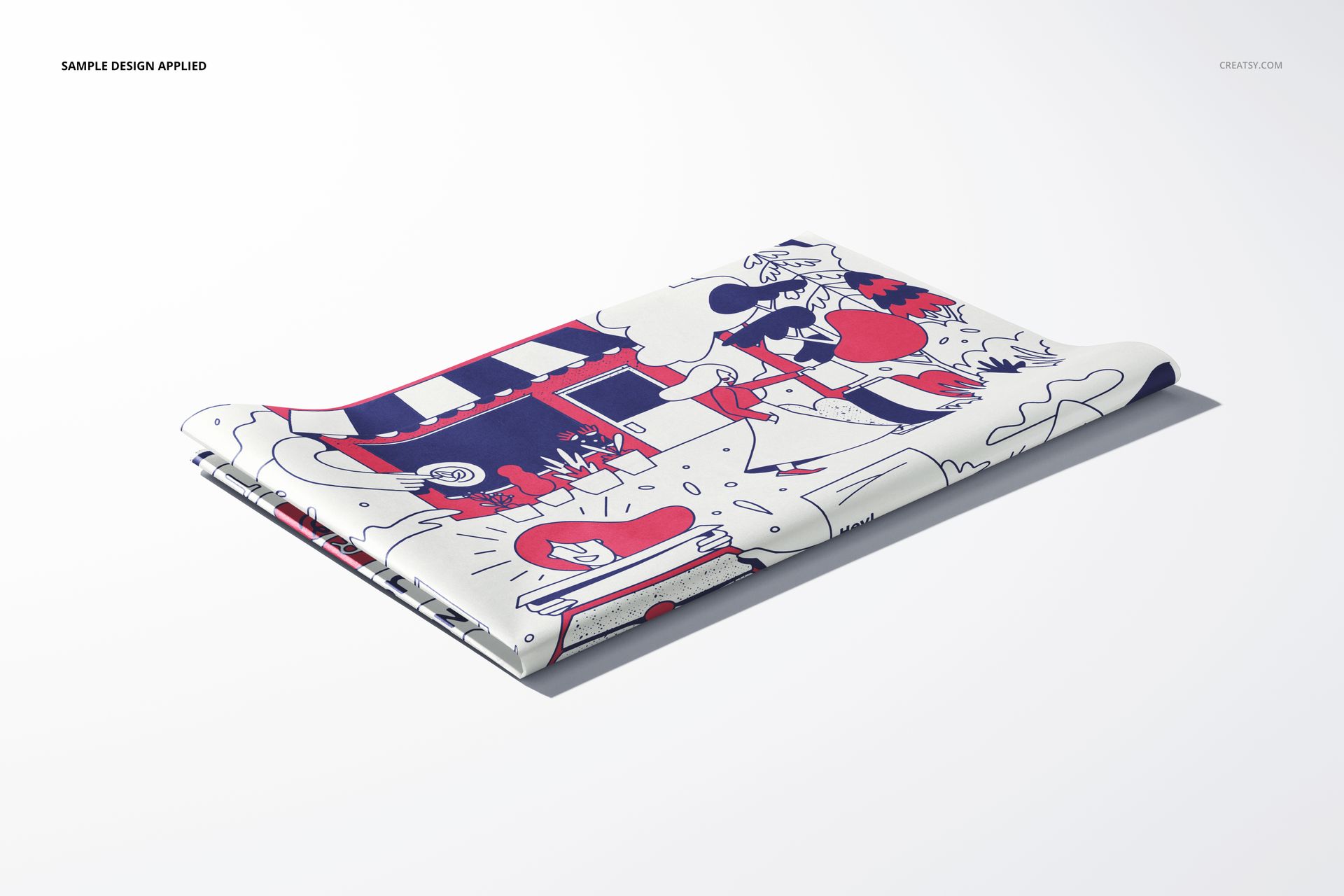 Front angled view of folded tissue paper mockup with playful illustrated design in red, blue, and white tones.