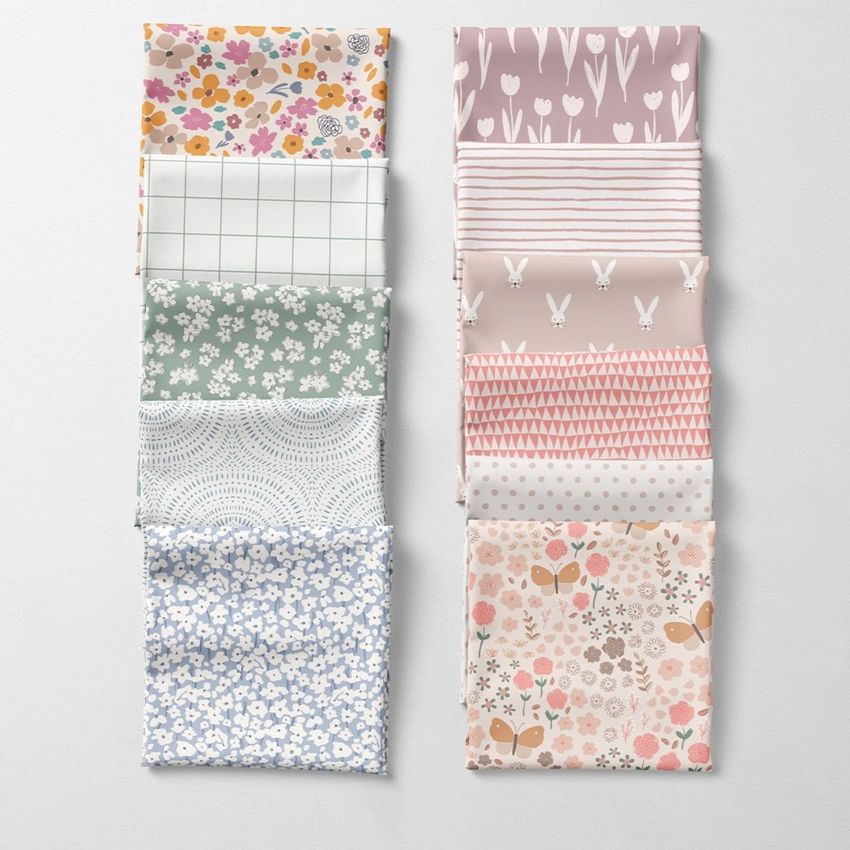 Folded fabrics mockup showing ten fabric squares arranged in two columns, each with different pastel floral and geometric patterns.