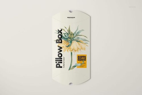 Rectangular pillow box mockup displayed flat, decorated with a large yellow flower and modern typography.