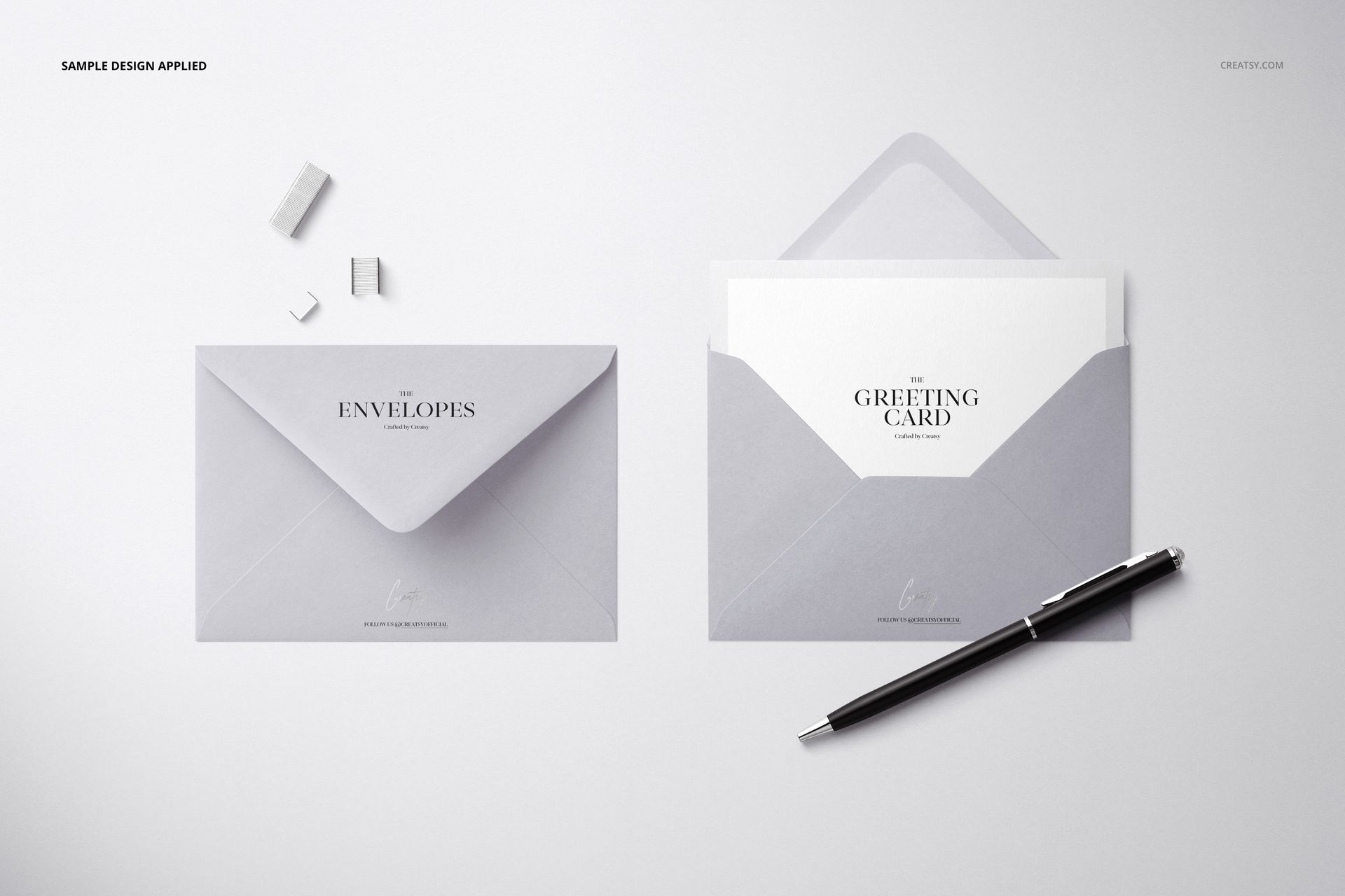 C6 envelope PSD mockup set featuring a minimal stationery arrangement with envelopes, card, pen, and paper clips.