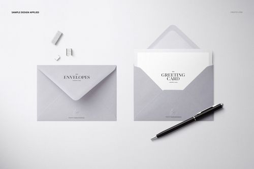C6 envelope PSD mockup set featuring a minimal stationery arrangement with envelopes, card, pen, and paper clips.