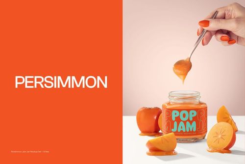 Front view of a persimmon jam jar mockup with orange label, surrounded by fresh persimmons and a hand holding a spoon.