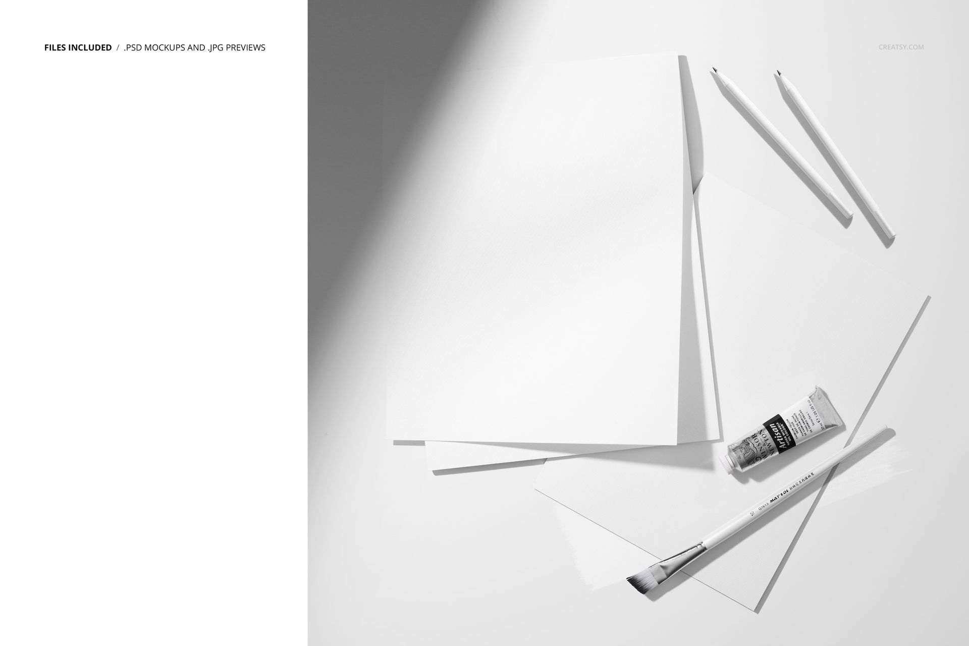 PSD mockup featuring art supplies with paper sheets, a pad, paintbrush, tube, and pencils in a minimalist white scene.