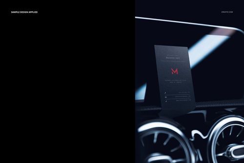 Black business card mockup displayed upright on a car dashboard with metallic air vents in a dark setting.