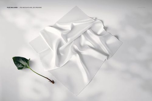 Square silk scarf mockup displayed in a perspective view, featuring soft folds and a plain white surface on a light background.