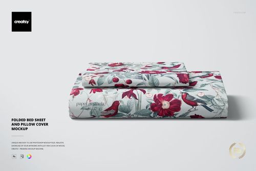PSD mockup showing a folded bed sheet and pillow cover featuring a botanical design with red flowers and birds.
