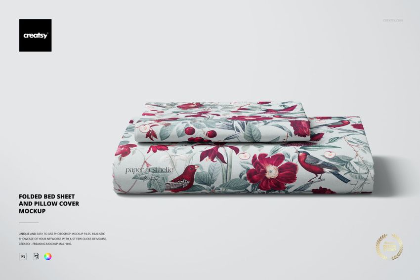 PSD mockup showing a folded bed sheet and pillow cover featuring a botanical design with red flowers and birds.
