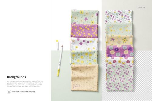 PSD mockup showing eight folded fabric samples with botanical prints, set on a light background with a pencil nearby.