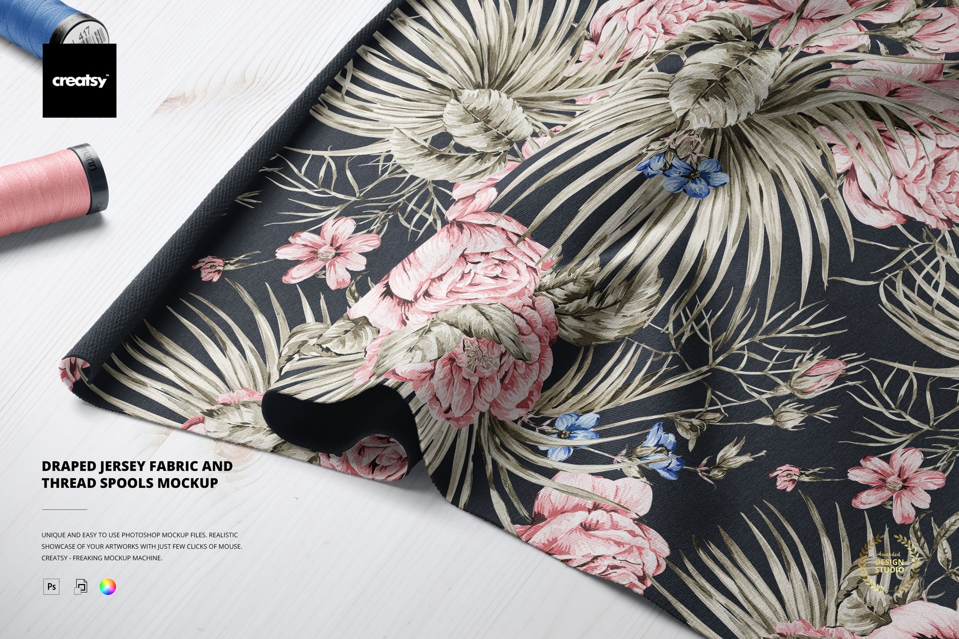 Jersey fabric mockup featuring a botanical print with palm leaves and flowers, displayed with pink and blue thread spools.