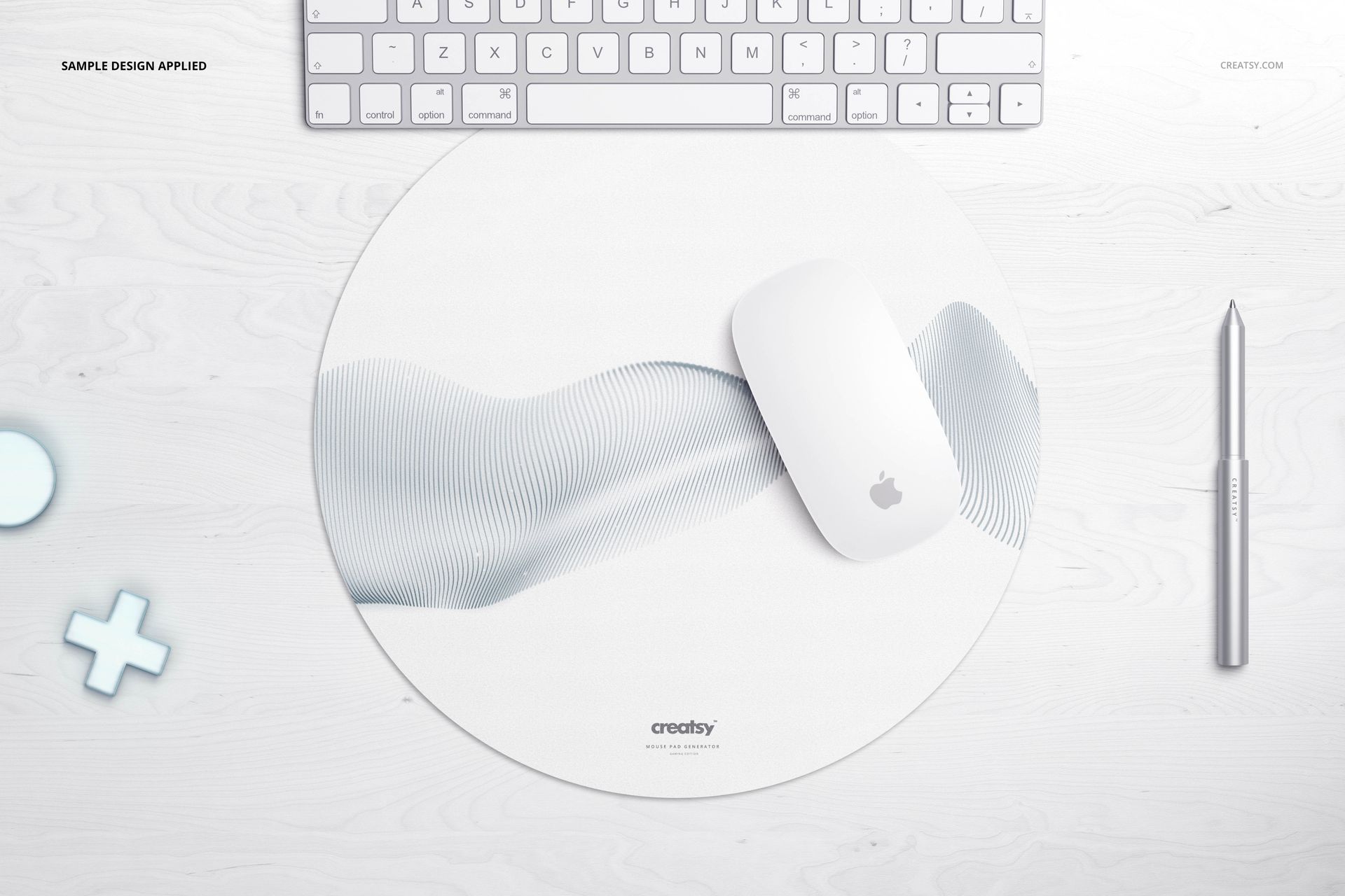 Circular mouse pad mockup featuring a light abstract wave design, placed on a white wood surface near accessories.