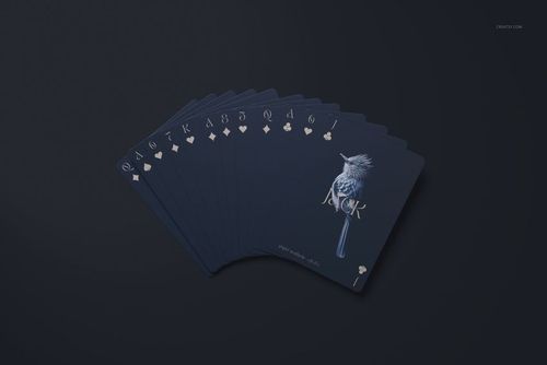 Top view of a set of playing cards mockup in deep blue tones, featuring a bird illustration and pale suit icons.