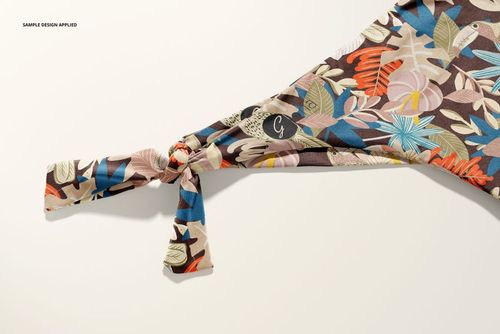 Bikini mockup showing side tie detail, decorated with vibrant leaves and flowers in blue, pink, and beige tones.