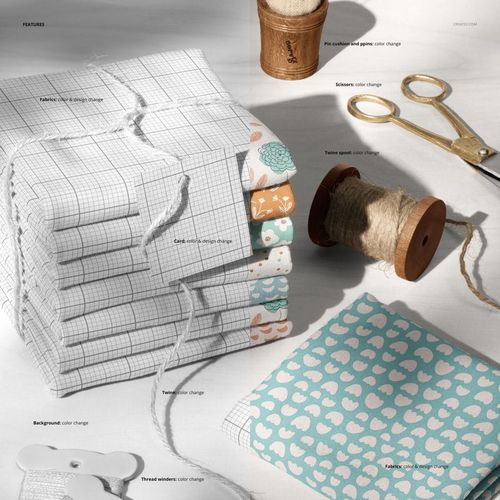 Stack of folded jersey fabrics in various patterns and colors with twine and a paper tag, shown in a top-down mockup scene.