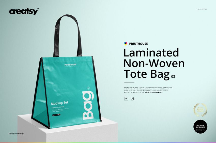 Front angled view of a laminated non-woven tote bag mockup with turquoise sides, black handles, and black trim on a light background.