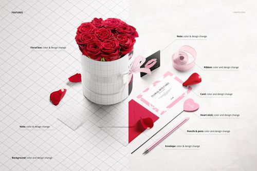 Floral box mockup featuring a cylindrical box with red roses, ribbon, cards, and envelopes on a white and grid surface.