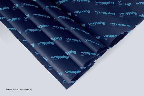 Dark blue wrapping tissue paper mockup with turquoise repeating text, arranged in neat folds on a light surface.