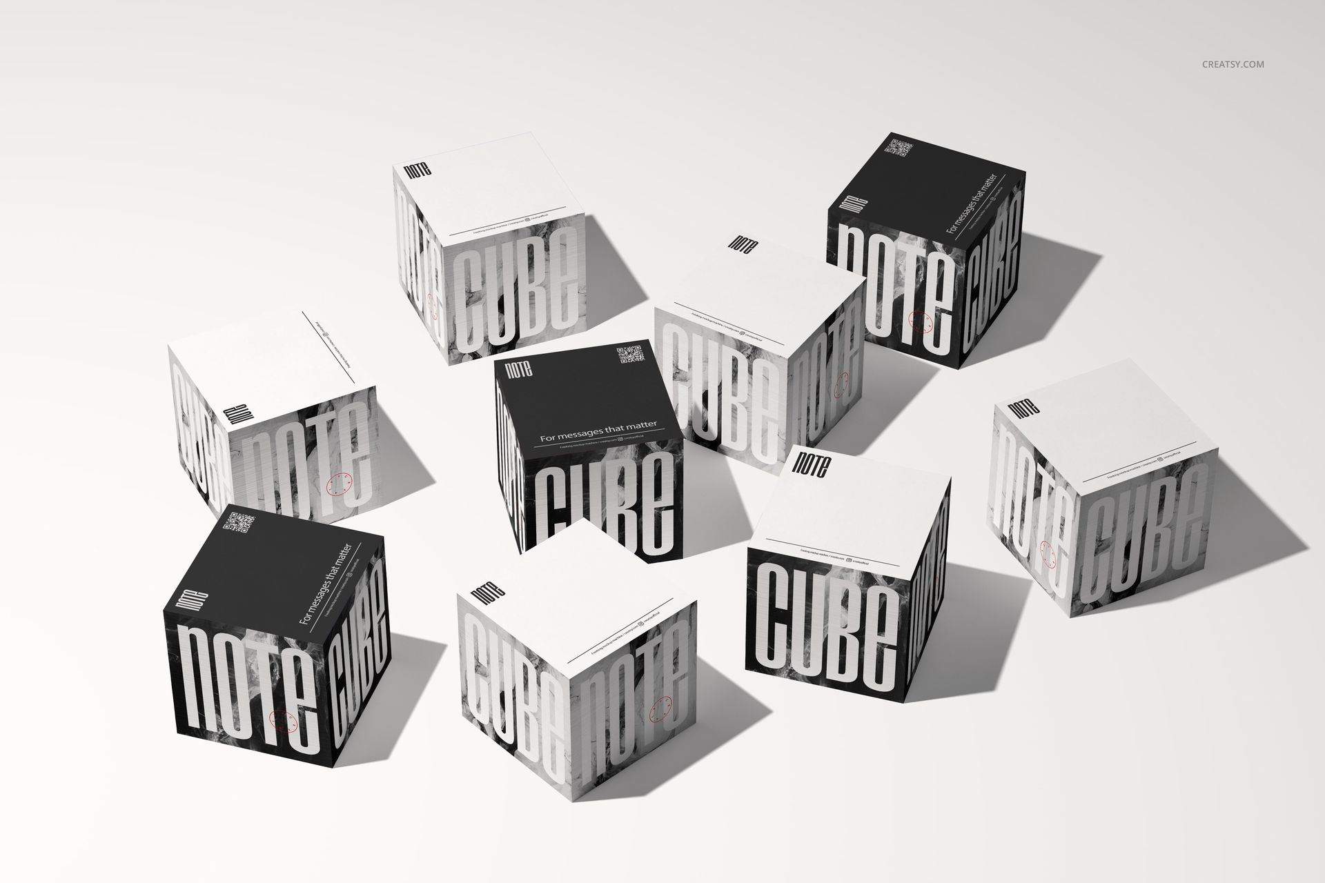 Eight note cube mockups arranged on a light surface, featuring black and white sides with bold text designs.