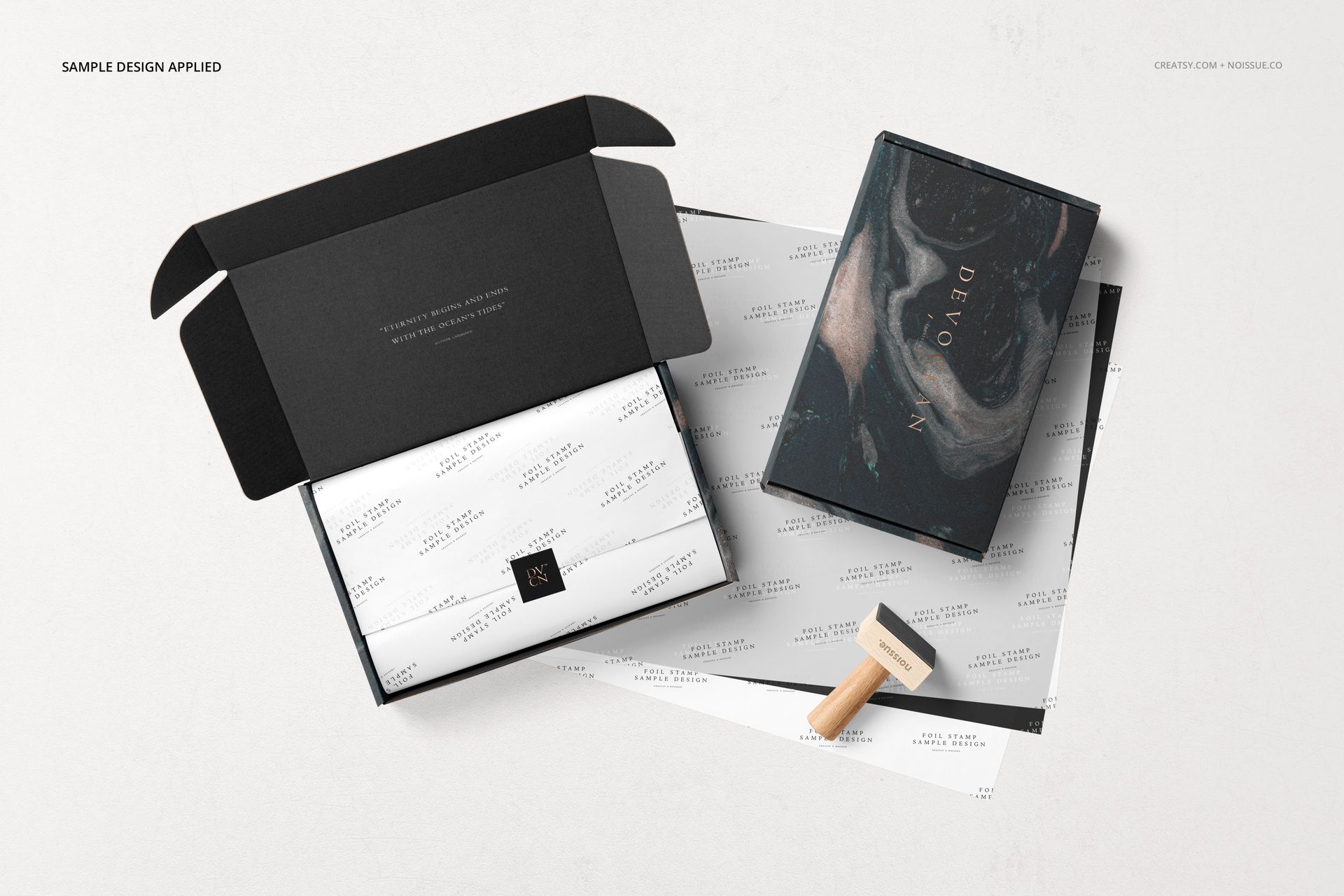Mailing box mockup set featuring an open black box with tissue paper, a closed box, and a wooden stamp on a pale background.