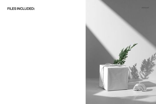 Christmas gift box mockup featuring white packaging, pine branch accent, and a rainbow ornament in bright sunlight.