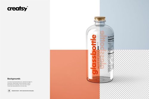 Clear glass bottle with a gold cap standing upright, featuring vertical text on the label, shown in a mockup scene.